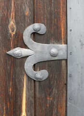 Decorative metal fittings on an old wooden gate