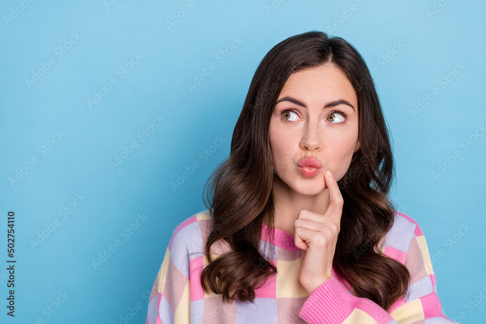 Sticker Photo of young pretty girl finger touch chin guess look empty space feelings romance isolated over blue color background