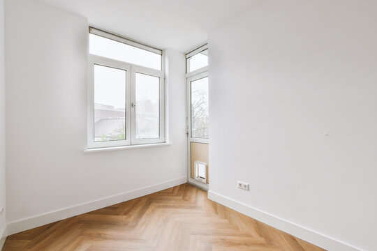 Corner of the empty room with window and door