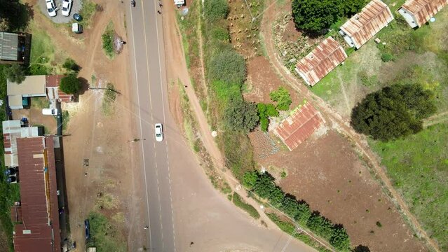 Aerial view of cars and people at a Open Air Market, in Africa - reverse, drone shot