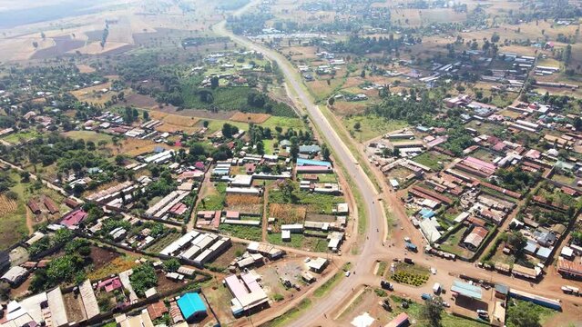 Aerial view of cars and people at a Open Air Market, in Africa - reverse, drone shot