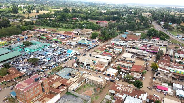 Aerial view of cars and people at a Open Air Market, in Africa - reverse, drone shot