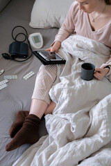 Medicine. The girl is sick at home in bed, next to pills, thermometer, medicines. Virus and...