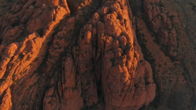 Aerial shot lowering over Utah's Snow Canyon State Park during sunrise.