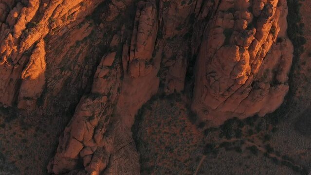 Top down aerial shot of Snow Canyon's mountains at sunrise.
