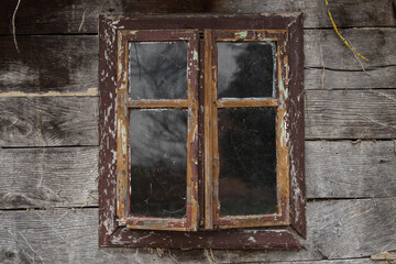 Croatia, May 01,2022 : Rustic style aged window at rural home wall.