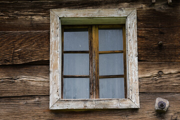 Naklejka na ściany i meble Croatia, May 01,2022 : Rustic style aged window at rural home wall.
