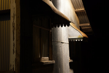 Metal window hood building detail on an old corrugated iron dance hallo.