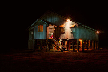 Old corrugated iron dance hall at Dows Creek in Central Queensland lit up for another dance night.