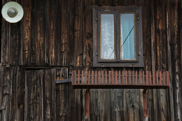 Obraz na płótnie Canvas Croatia, May 01,2022 : Rustic style aged window at rural home wall.