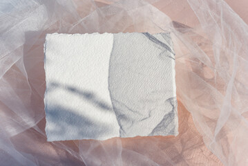 Obraz premium Minimalistic stylish wedding card mock up with green branch. Flat lay, top view. Mockup card with plants. Wedding invitation card with environment and details