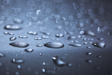 Abstract macro shot closeup of water drops on a metallic surface.