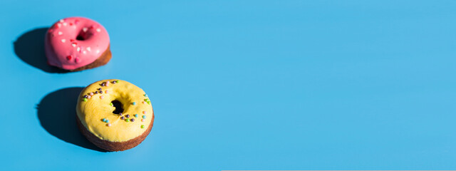 Trendy sunlight. Summer doughnuts on bright light blue turquoise background banner and place for advertising - Minimal summer concept. Pop art style. Donut