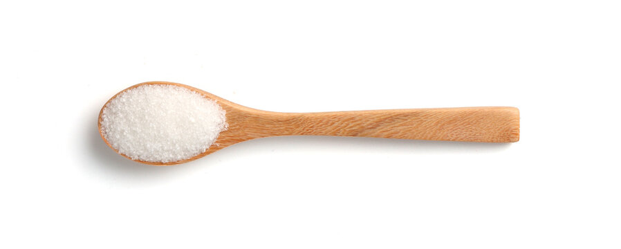 White sugar in wooden spoon isolated on white background