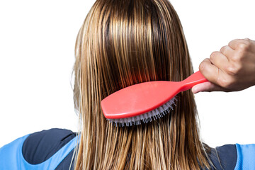 Woman combing her wet hair with a massage comb on a white background