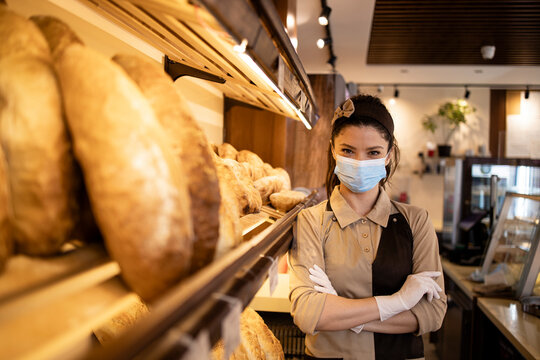 Portrait of bakery seller wearing face mask in supermarket.