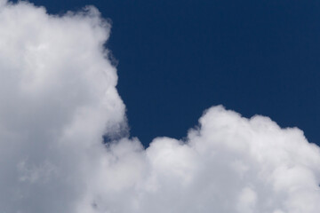 white fluffy cloud against blue sky