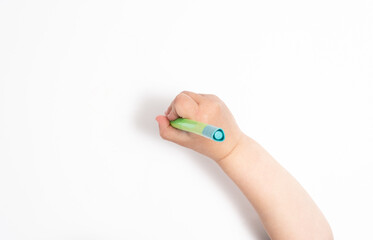 Little chilld's hand holds a pen