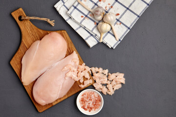 Chopped minced chicken breast fillet of poultry on a cutting board garlic and pink salt