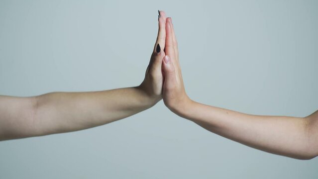 Man and girl giving high five. Two hands, male and female. High-five gesture and tenderness of friendship between man and woman. High five concept for success, teamwork, congratulating, celebration