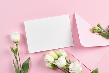 Invitation card mockup with envelope and white eustoma flowers