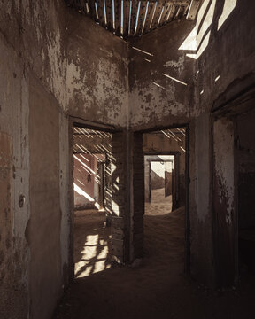 Inside destroyed buildings. Photo from the ghost town of Kolmanskop, nearby L&uuml;deritz, in the Namib desert. Namibia, Africa.