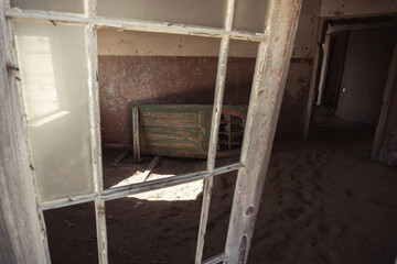 Inside destroyed buildings. Photo from the ghost town of Kolmanskop, nearby Lüderitz, in the Namib desert. Namibia, Africa.
