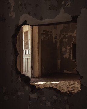 Inside destroyed buildings. Photo from the ghost town of Kolmanskop, nearby L&uuml;deritz, in the Namib desert. Namibia, Africa.