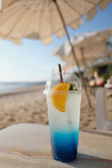 blue lemon soda on the beach table