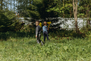 little boys with butterfly nets in countryside. Image with selective focus