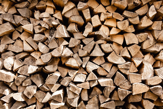 Background of stacked firewood. Chopped firewood.