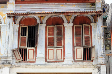 Beautiful ruined vintage wooden windows of an old Chinese shop house in the heritage town of Georgetown in Penang, Malaysia.