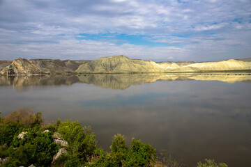 Blue clouds with reflection of colorful mountain in lake