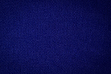 Navy blue color felt textile fabric material texture background. Abstract monochrome dark blue...