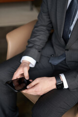 Businessman using his mobile phone. Male hands using smartphone. Cell phone Mockup image blank. Man hand holding, texting, using mobile. Background empty space for advertise. 
