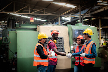 group of diversity teamwork, engineers, technician and workers team in safety uniform are happy morning talk before the start of work in heavy industrial manufacturer factory.