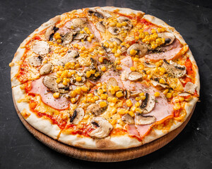 hot delicious traditional italian pizza on a dark stone background