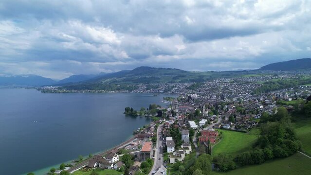 Establish city Richterswil in Switzerland on a cloudy summer day, aerial view