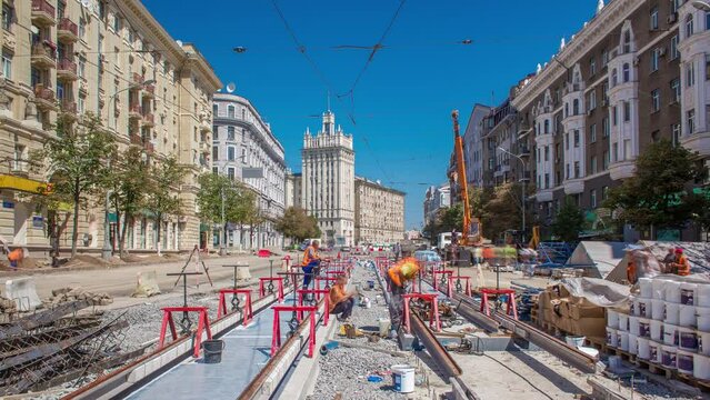 Tram rails at the final stage of their installation and integration into concrete plates on the road timelapse with crane. Filling by liquid resin for reduction of vibration and noice. The process of