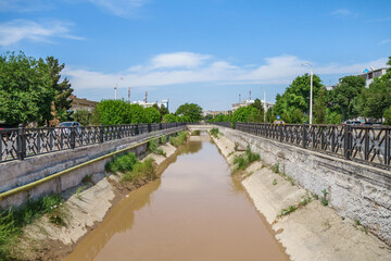 Fototapeta na wymiar City river canal in Bukhara, Uzbekistan. River that flows is Zerafshan