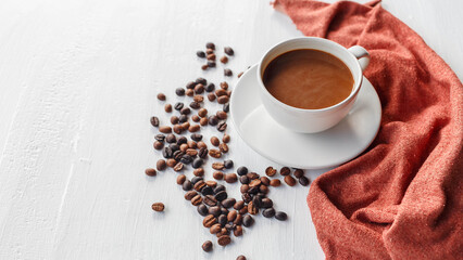 coffee cup and coffee beans on white wooden background