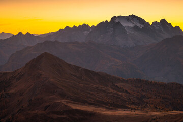 Autumn in the Italian Dolomites. The most beautiful time of the year to visit this place. Beautiful colors and breathtaking views. Mountain peaks above the valleys.