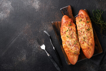 Baguette boats. Hot baked sandwich on baguette bread with ham, bacon, vegetables and cheese on...