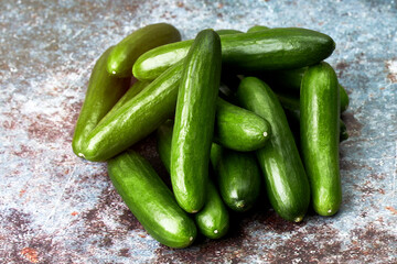 Pile of healthy and ecological baby cucumbers. Vegan and vegetarian food