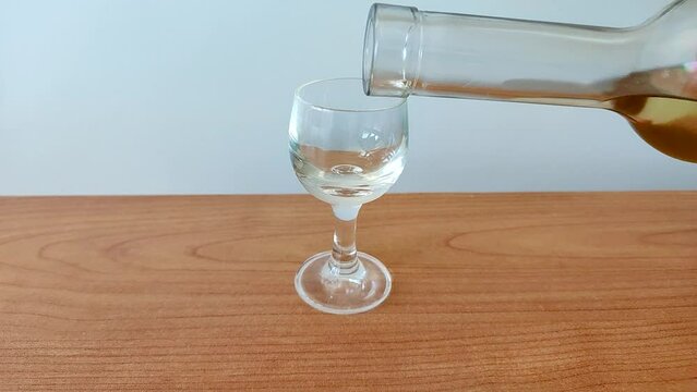 Pour a glass with chacha from the bottle. Chacha is Georgian pomace brandy.