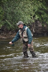 Fototapeta premium An angler fishing on a river 