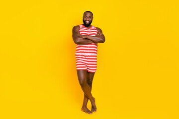 Photo stylish trendy guy cross arms save sea ocean swimmers wear striped overall shorts isolated shine color background