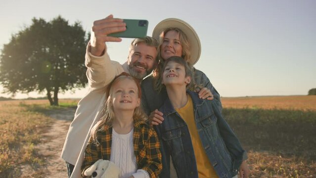 Close up family taking selfie photo in field. Children, mother, kid, spending time, childhood, summer. Portrait. Slow motion