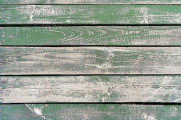 Wooden background. Old green painted wooden plank surface, aged weathered cracked boards. Grunge...