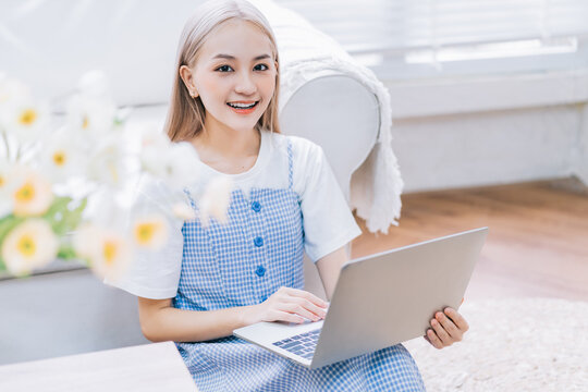 Young Asian girl using laptop at home